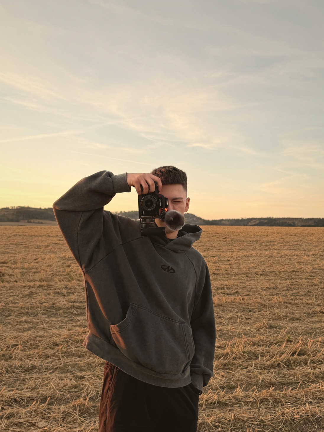 Sebastian Dorsch beim Fotografieren auf einem Feld bei Sonnenuntergang